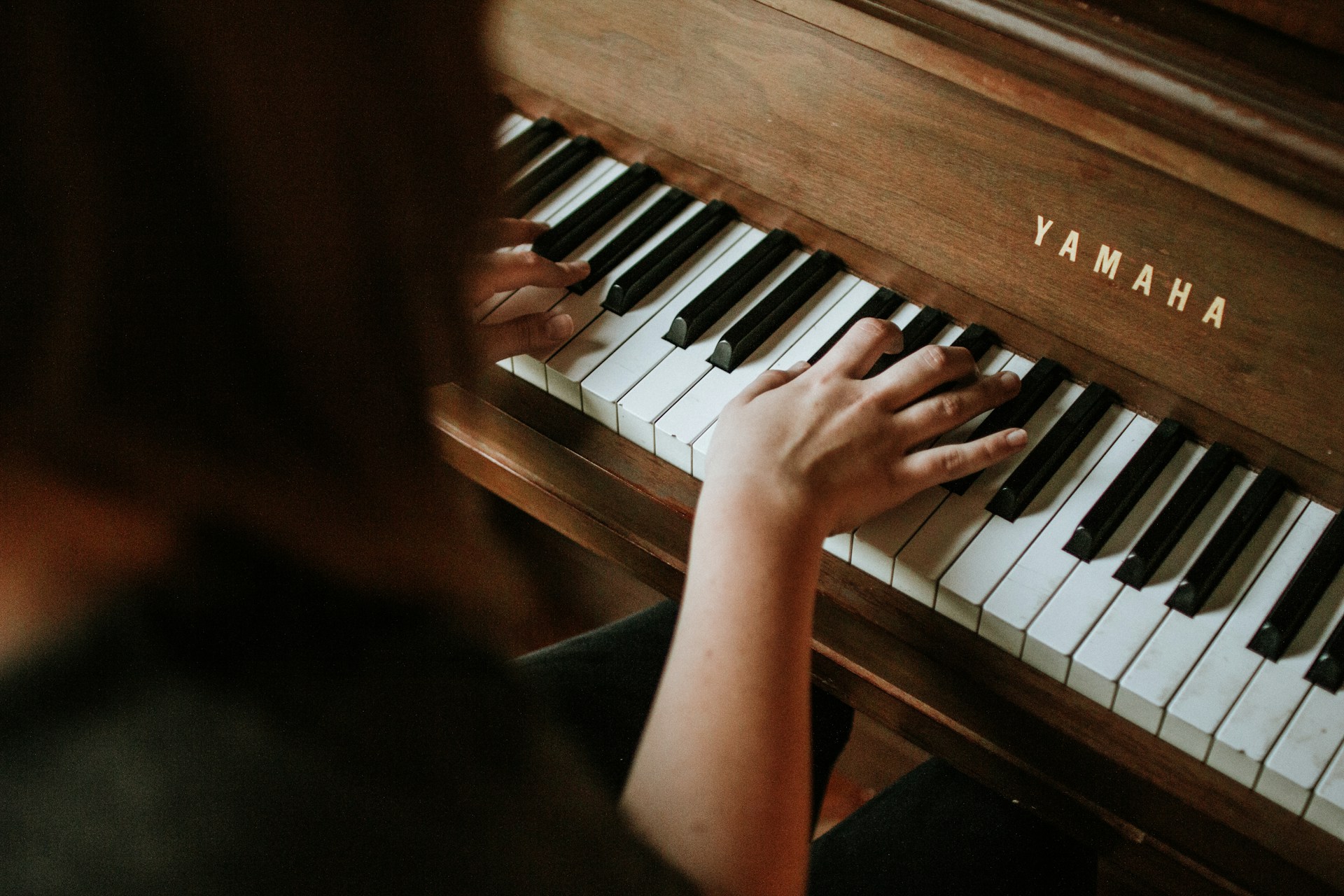 girl playing a yamaha piano